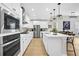 Modern white kitchen with stainless steel appliances, large island, and pendant lighting at 206 River Martin Ct, Summerville, SC 29483