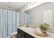 Bathroom with granite countertop, dark wood vanity, and blue striped shower curtain at 2301 Ardeer Dr, Charleston, SC 29414