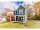 Picturesque blue two-story house with a front porch, rocking chairs, and landscaped yard at 2301 Ardeer Dr, Charleston, SC 29414