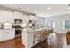 Modern white kitchen with stainless steel appliances, granite countertops, and island with seating at 2301 Ardeer Dr, Charleston, SC 29414