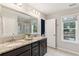 Double vanity with dark cabinets and large mirror in the main bathroom at 2301 Ardeer Dr, Charleston, SC 29414