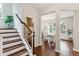 Elegant entryway with wooden staircase, hardwood floors, and access to dining area at 2301 Ardeer Dr, Charleston, SC 29414