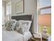 Main bedroom with plush bedding, gray headboard, and large window at 368 Trailmore Ln, Summerville, SC 29486