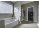 Relaxing bathroom featuring a garden tub, walk-in closet, and neutral tile at 3705 Tower Dr, Mount Pleasant, SC 29466