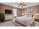 Virtually staged bedroom with mauve walls and king bed at 373 Whispering Breeze Ln, Summerville, SC 29486