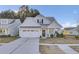 Two-story house with white siding, gray roof, and a two-car garage at 373 Whispering Breeze Ln, Summerville, SC 29486