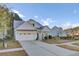 White two-story house with a gray roof and a two-car garage at 373 Whispering Breeze Ln, Summerville, SC 29486