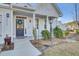Front entry with gray door, white columns and landscaping at 373 Whispering Breeze Ln, Summerville, SC 29486