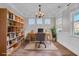 Virtually staged home office with built-in shelving and hardwood floors at 373 Whispering Breeze Ln, Summerville, SC 29486