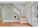 Wooden staircase with white railing and access to upper level at 373 Whispering Breeze Ln, Summerville, SC 29486