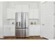 Bright kitchen boasts stainless steel refrigerator and white cabinetry at 428 Parish Farms Dr, Summerville, SC 29486