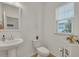 Clean and bright half bathroom with pedestal sink and window at 432 Eva St, Moncks Corner, SC 29461