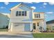 Two-story white house with a green door, landscaping, and a two-car garage at 432 Eva St, Moncks Corner, SC 29461