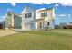 Two-story white house with a green door, landscaping, and a two-car garage at 432 Eva St, Moncks Corner, SC 29461