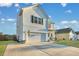Two-story white house with a green door, landscaping, and a two-car garage at 432 Eva St, Moncks Corner, SC 29461