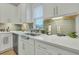 Kitchen sink and counter with white cabinets and green tile backsplash at 432 Eva St, Moncks Corner, SC 29461