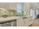 Kitchen features white cabinets, stainless steel dishwasher, and green tile at 432 Eva St, Moncks Corner, SC 29461