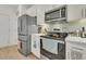 Stainless steel range and microwave in a white kitchen setting at 432 Eva St, Moncks Corner, SC 29461