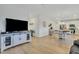 Living room with open kitchen view, TV, and hardwood floors at 432 Eva St, Moncks Corner, SC 29461
