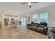 Open living room with kitchen view, hardwood floors, and sofas at 432 Eva St, Moncks Corner, SC 29461