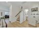 Modern staircase with light wood steps and a half-bath visible down the hall at 432 Eva St, Moncks Corner, SC 29461