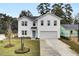 White two-story home with a one-car garage and landscaping at 5028 Scow Ct, Summerville, SC 29485