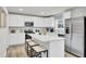 Modern white kitchen with stainless steel appliances, quartz countertops, and an island at 5028 Scow Ct, Summerville, SC 29485