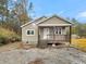 Newly built home with tan siding, wooden porch and steps at 5330 Halfway Creek Rd, Huger, SC 29450