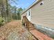 Side view of house with wooden stairs and brick walkway at 5330 Halfway Creek Rd, Huger, SC 29450