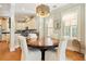 Elegant dining area adjacent to the kitchen with a round wooden table and seating for four at 656 Coleman Blvd # 405, Mount Pleasant, SC 29464