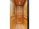 Interior of a home elevator featuring wood paneling, hardwood flooring, and recessed lighting at 656 Coleman Blvd # 405, Mount Pleasant, SC 29464