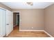 Well-lit bedroom with access to hallway and laminate floors at 7911 Timbercreek Ln # A, North Charleston, SC 29418