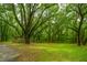 Lush backyard with a storage shed, fenced area, and mature trees at 8389 Chisolm Plantation Rd, Edisto Island, SC 29438