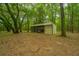 Metal barn with a lean-to in a wooded setting at 8389 Chisolm Plantation Rd, Edisto Island, SC 29438