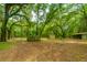 Property with two barns, a gate, and a gravel driveway at 8389 Chisolm Plantation Rd, Edisto Island, SC 29438