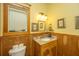 Bathroom featuring wood vanity, toilet, and decorative accents at 8389 Chisolm Plantation Rd, Edisto Island, SC 29438