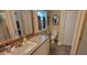 Bathroom with vanity, toilet, and wood-framed mirror at 8389 Chisolm Plantation Rd, Edisto Island, SC 29438