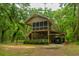 Charming two-story home with a screened porch, carport, and lush landscaping at 8389 Chisolm Plantation Rd, Edisto Island, SC 29438