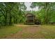 Two-story home with a screened porch, carport, and landscaped yard at 8389 Chisolm Plantation Rd, Edisto Island, SC 29438