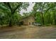 Two-story home with a gravel driveway and lush landscaping at 8389 Chisolm Plantation Rd, Edisto Island, SC 29438