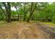 Exterior view of a two-story home nestled among trees with a driveway at 8389 Chisolm Plantation Rd, Edisto Island, SC 29438