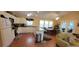 Bright kitchen with white cabinets, an island, and a dining area at 8389 Chisolm Plantation Rd, Edisto Island, SC 29438