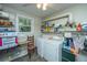 Laundry room with washer, dryer, and ample shelving at 8389 Chisolm Plantation Rd, Edisto Island, SC 29438