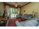 Living room with sliding glass doors, wood-paneled walls, and plush seating at 8389 Chisolm Plantation Rd, Edisto Island, SC 29438