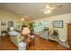 Living room with two sofas, a floral chair, and parquet flooring at 8389 Chisolm Plantation Rd, Edisto Island, SC 29438
