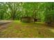 Outbuilding situated on a grassy area within a wooded setting at 8389 Chisolm Plantation Rd, Edisto Island, SC 29438