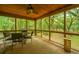 Relaxing screened porch with seating area and wooded views at 8389 Chisolm Plantation Rd, Edisto Island, SC 29438