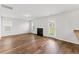 Bright living room with wood-look floors, a fireplace, and a door leading to the backyard at 103 Clarabelle Ln, Summerville, SC 29483