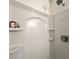 White shower with built-in shelves and a handheld shower head at 1329 Camp Rd, Charleston, SC 29412