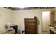 Bedroom featuring wooden dresser, nightstand, and doorway to another room at 141 Wintergreen Rd, Walterboro, SC 29488